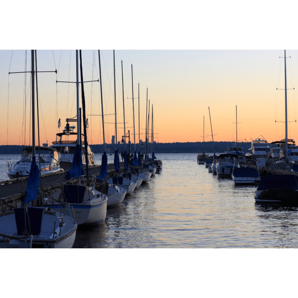 Sail boats in a harbor at sunset in Kirkland, Washington.