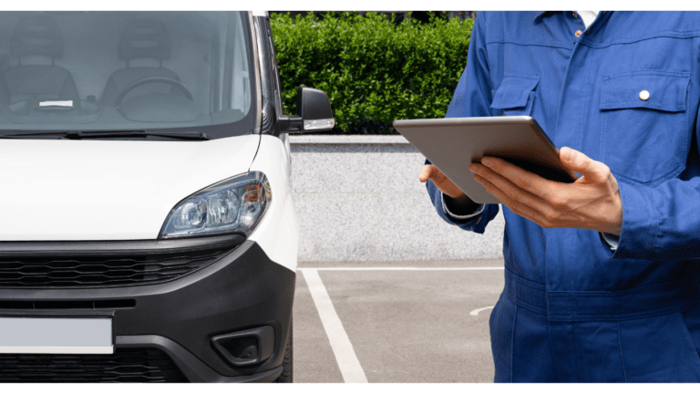 Commercial fleet manager inspecting his fleet and recording data on a tablet.